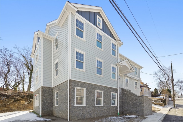 view of home's exterior with board and batten siding and stone siding