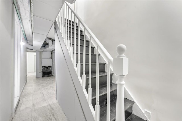 stairway featuring marble finish floor