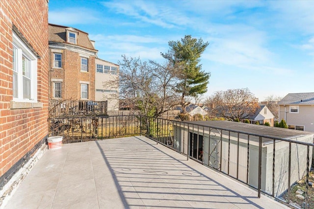 view of patio featuring a residential view and a balcony