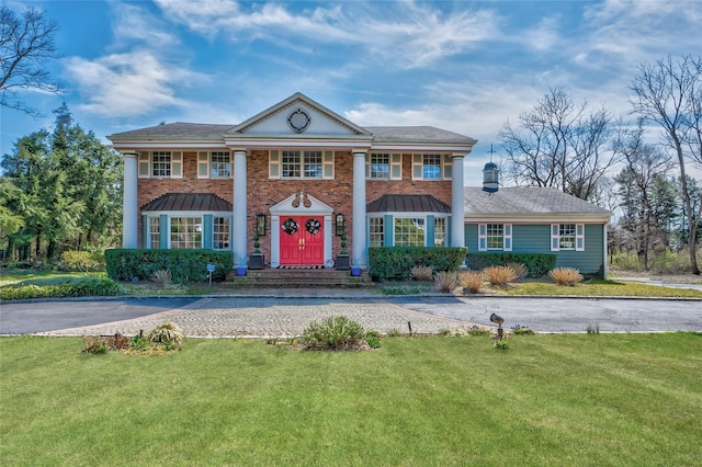 neoclassical home with a front yard