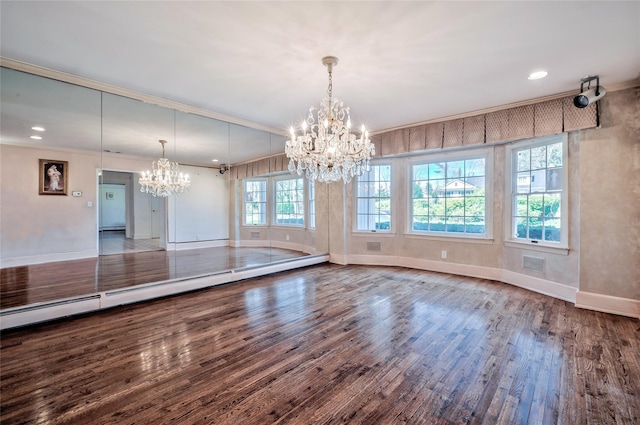 unfurnished dining area with wood-type flooring, an inviting chandelier, a baseboard heating unit, and ornamental molding