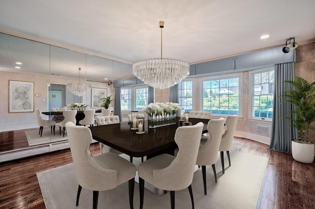 dining space with wood-type flooring, crown molding, a wealth of natural light, and a notable chandelier