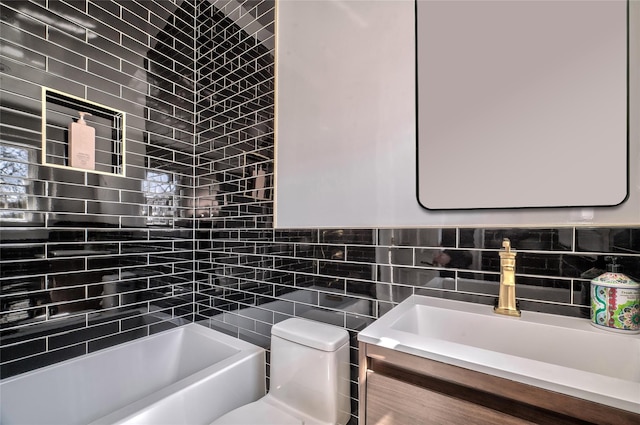 bathroom featuring vanity, a bathtub, toilet, and tile walls