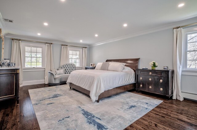 bedroom with baseboard heating, dark hardwood / wood-style floors, and ornamental molding