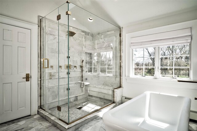 bathroom featuring a baseboard heating unit, shower with separate bathtub, and vaulted ceiling