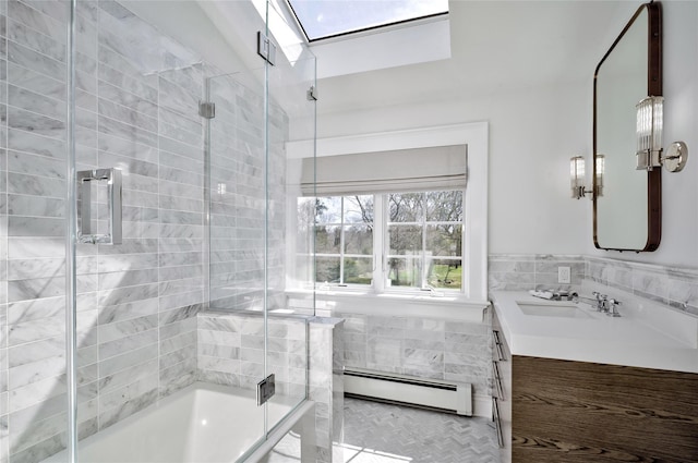 bathroom featuring vanity, combined bath / shower with glass door, and a baseboard radiator