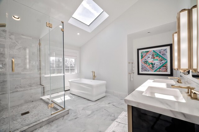 bathroom with shower with separate bathtub, vanity, and vaulted ceiling with skylight