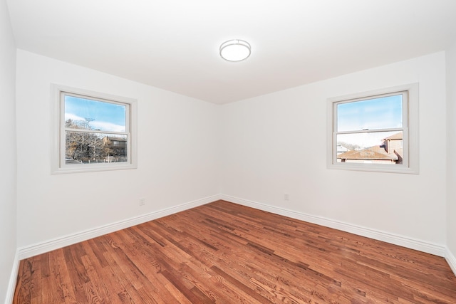 empty room featuring hardwood / wood-style floors and a healthy amount of sunlight