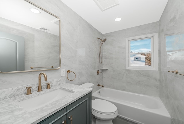 full bathroom featuring vanity, toilet, and tiled shower / bath