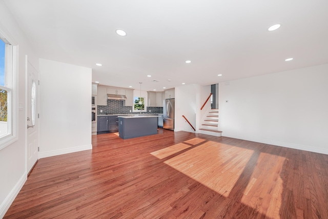 unfurnished living room with wood-type flooring