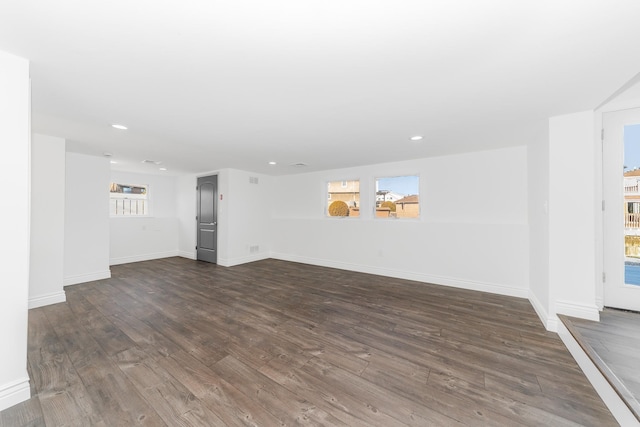 unfurnished living room featuring dark wood-type flooring