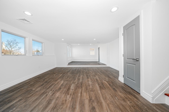 unfurnished living room with dark wood-type flooring