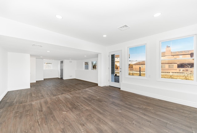 unfurnished living room featuring dark wood-type flooring