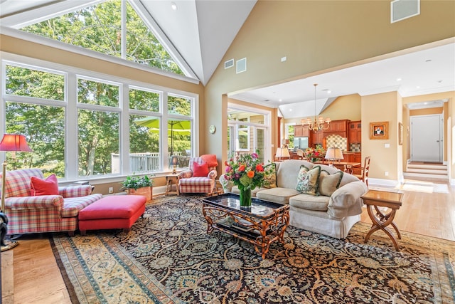 sunroom / solarium featuring lofted ceiling and a notable chandelier