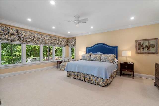 bedroom with ceiling fan, ornamental molding, and carpet floors