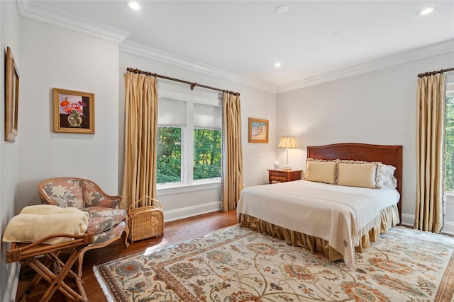 bedroom featuring hardwood / wood-style flooring and crown molding