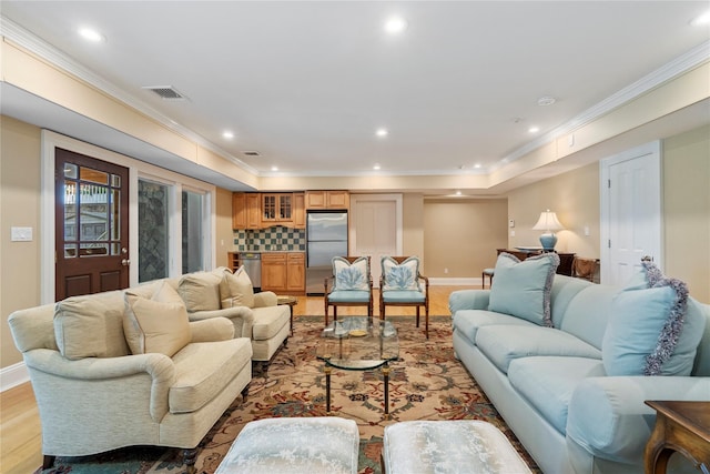 living room with crown molding and light wood-type flooring