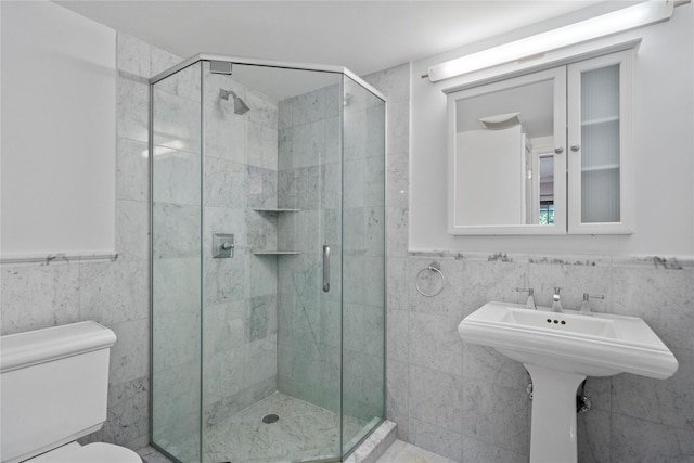 bathroom featuring toilet, tile walls, and walk in shower