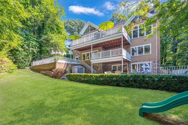 rear view of house with a playground and a lawn