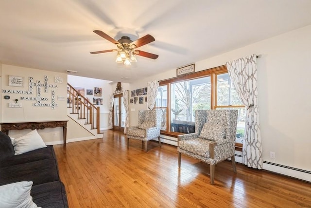 unfurnished living room featuring wood-type flooring and ceiling fan