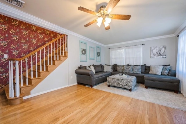 living room with crown molding, ceiling fan, and wood-type flooring