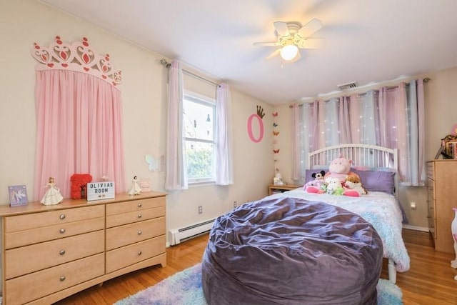 bedroom with light wood-type flooring, baseboard heating, and ceiling fan