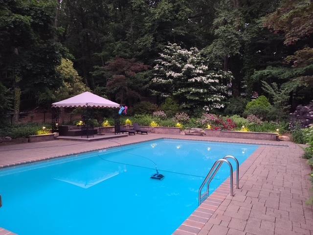 view of swimming pool with a gazebo and a patio area