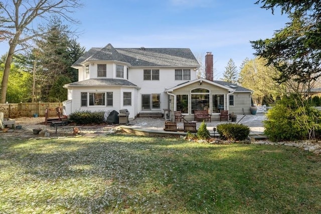 rear view of property with a yard and a patio