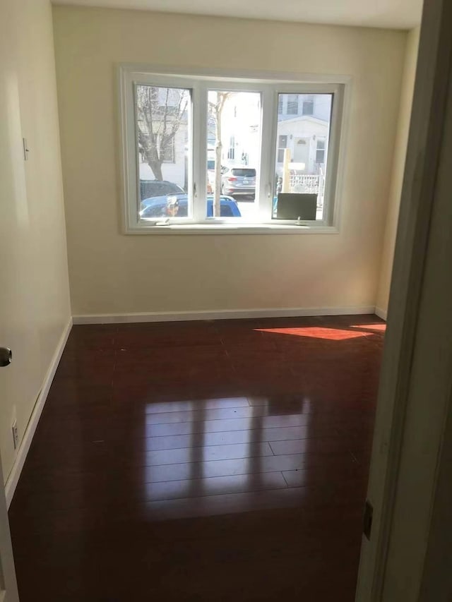 unfurnished room with dark hardwood / wood-style floors