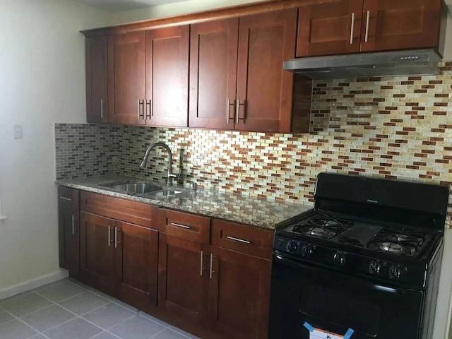 kitchen featuring light stone countertops, backsplash, black range with gas stovetop, sink, and light tile patterned floors