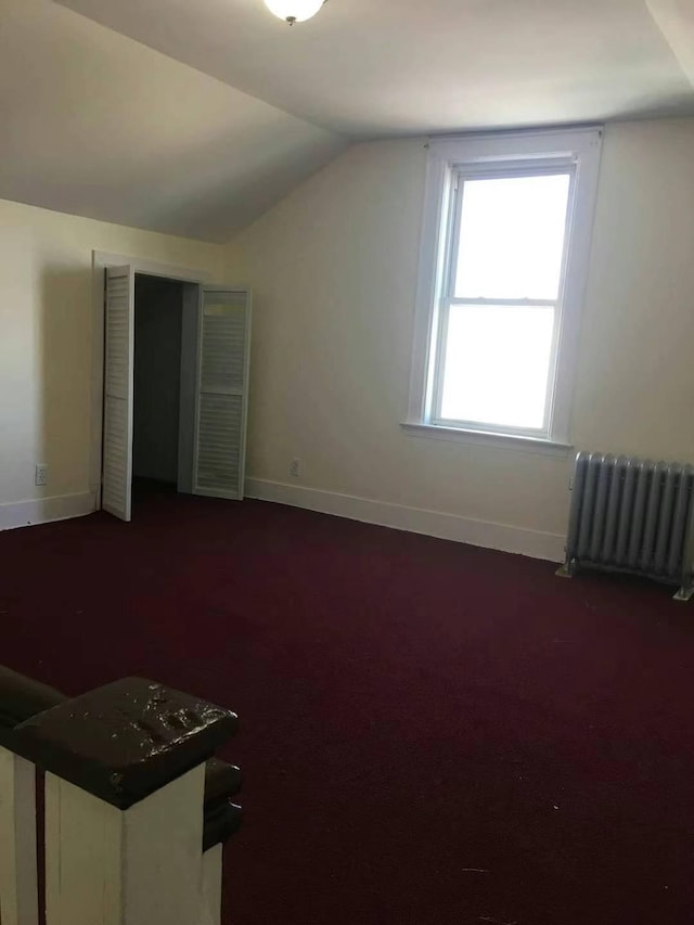 bonus room featuring radiator and lofted ceiling