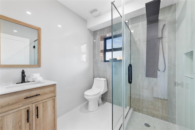 bathroom featuring vanity, tile patterned floors, a stall shower, and toilet