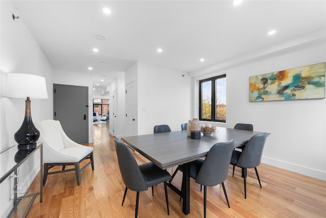 dining area with light wood-style floors, baseboards, and recessed lighting