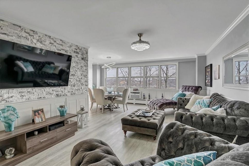 living room with crown molding and light wood-type flooring