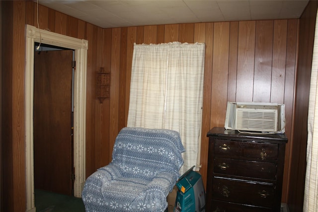 sitting room featuring wooden walls