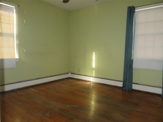 empty room with dark hardwood / wood-style flooring