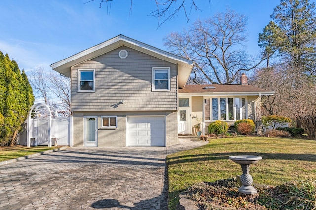 split level home featuring a garage and a front yard