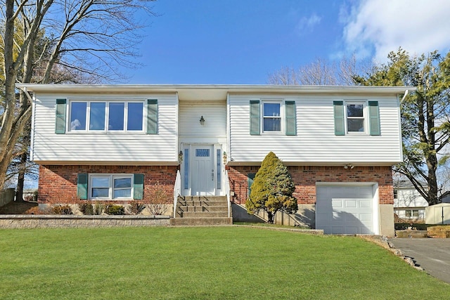 split foyer home featuring a front yard and a garage