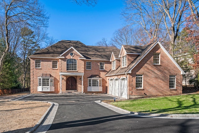 view of front facade with a garage and a front yard