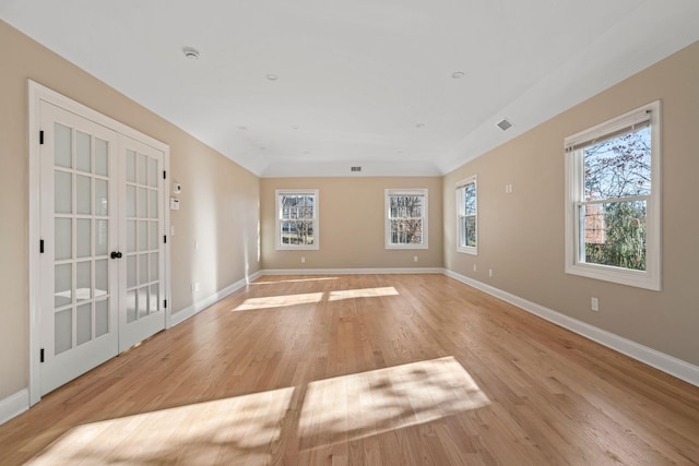 spare room featuring light wood-type flooring and french doors