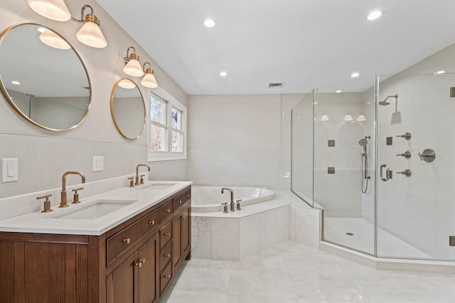 bathroom featuring independent shower and bath and vanity