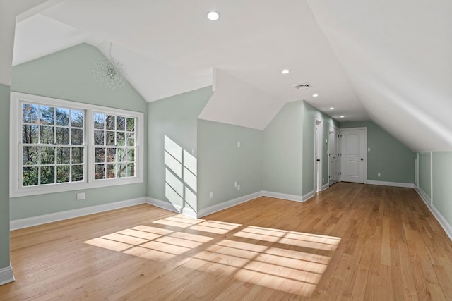 bonus room with lofted ceiling and light hardwood / wood-style flooring