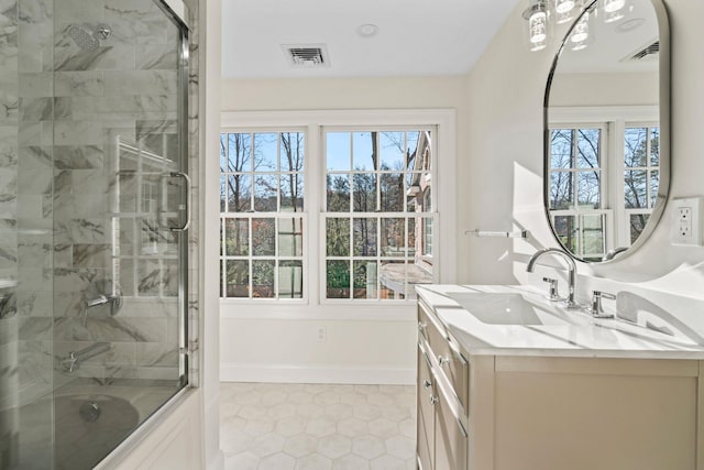 bathroom with bath / shower combo with glass door, tile patterned flooring, and vanity