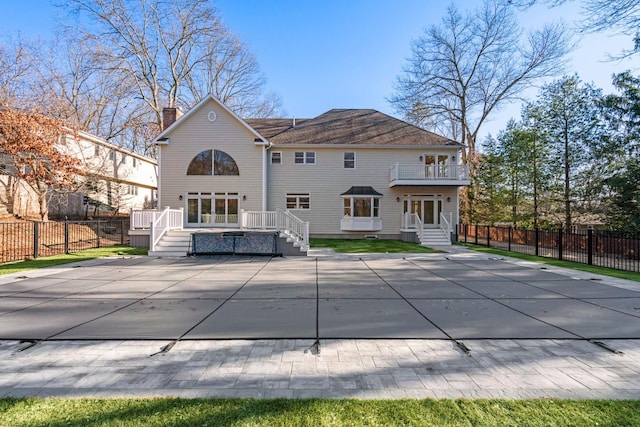 back of property featuring a balcony