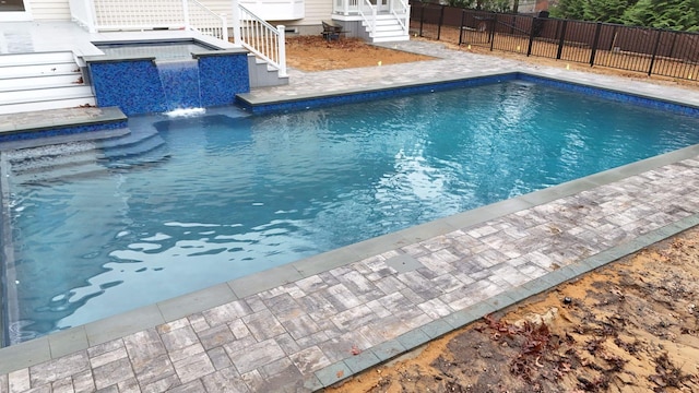 view of swimming pool with a jacuzzi