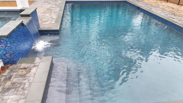 view of swimming pool featuring pool water feature