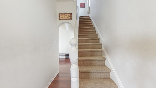 stairs with hardwood / wood-style flooring