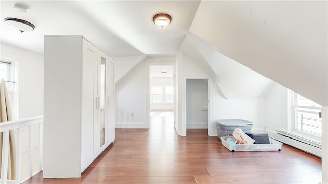 bonus room featuring baseboard heating and hardwood / wood-style floors