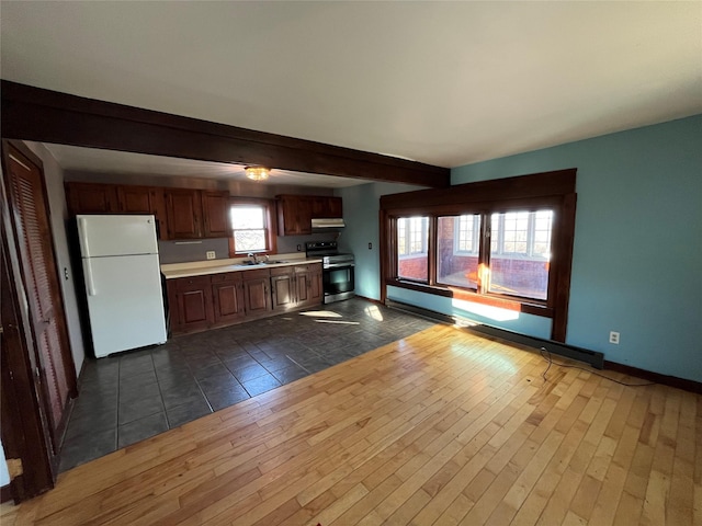 kitchen featuring dark wood-type flooring, electric range, plenty of natural light, and white refrigerator