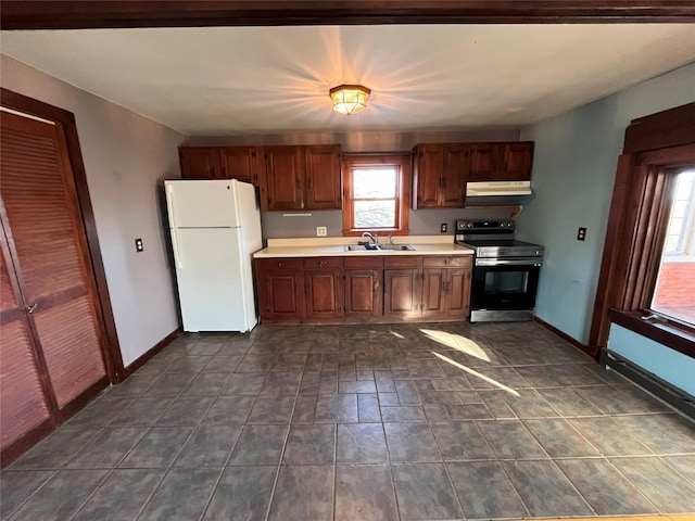 kitchen with white fridge, range with electric cooktop, and sink